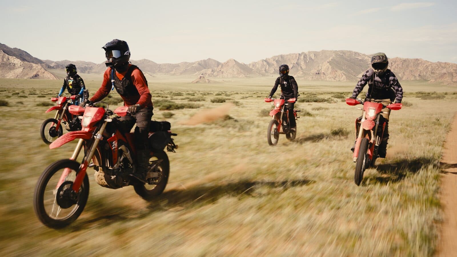 Motorcycles crossing the green Khangai highlands